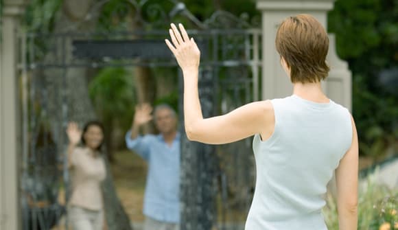 Woman waving at friends from a distance