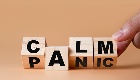 blocks spelling "Calm" on one side, "Panic" on the other