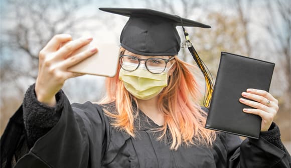 female graduate wearing face mask due to COVID-19