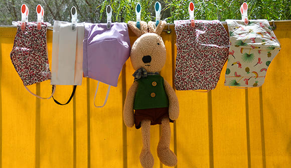 clothes line of cloth masks and stuffed animal bunny