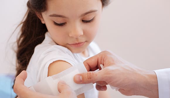 little girl receiving flu shot