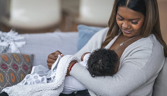 A woman breastfeeding her baby