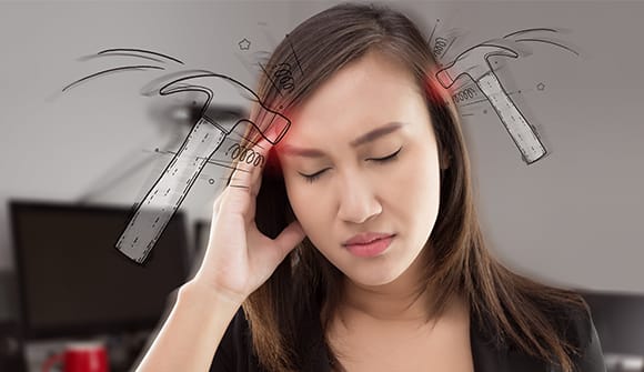 Woman with hand up to her head in pain