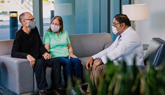 Joe Stauble and his wife, Cathy, talk with Subrato Deb, MD.