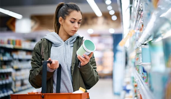 Woman looking at food label