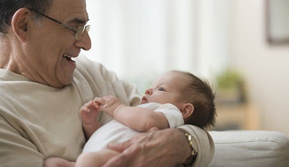 grandfather holding baby