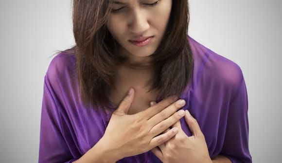 Foto de Woman with breast pain touching chest and controlling