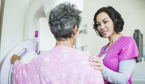 Provider reassures patient getting a screening mammogram