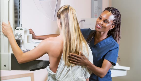 Provider reassures patient getting a screening mammogram