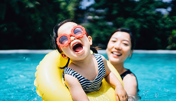 Child playing safely in pool