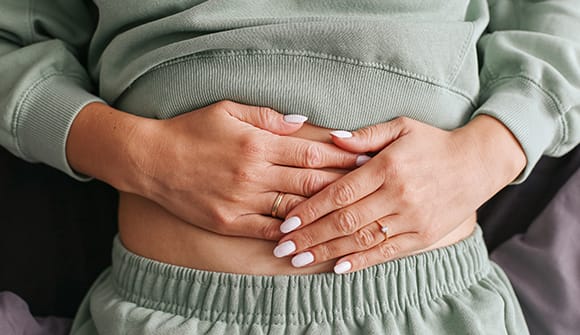 woman with hands on stomach