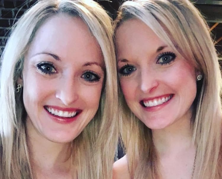identical twin sisters, who are both practicing OBGYNs in Jacksonville smile together
