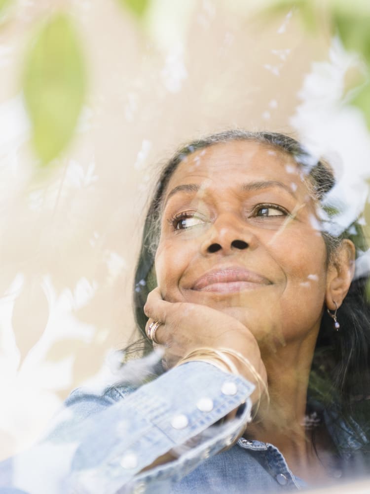 African american woman smiling as she looks out a sunny window