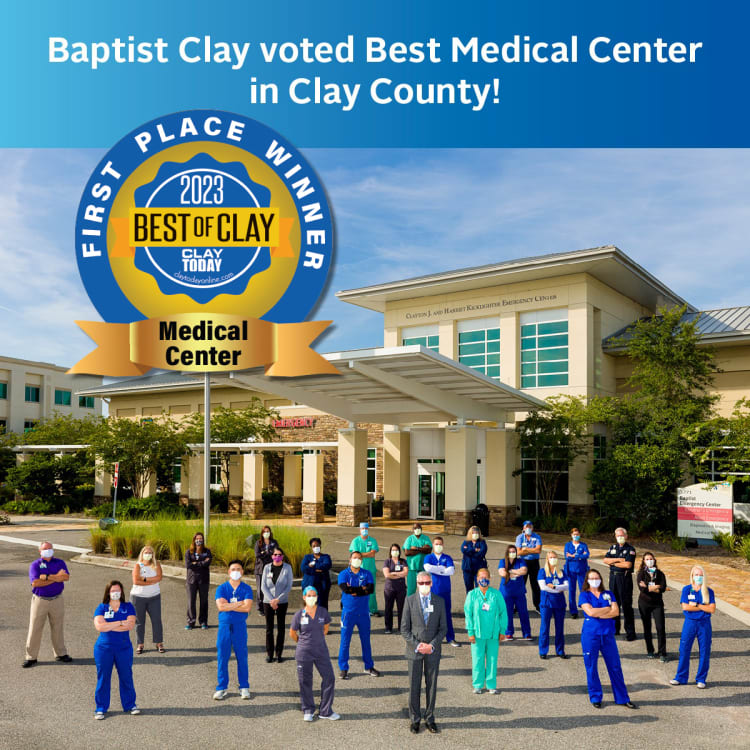 A group of Baptist Health employees standing in front of the Baptist Clay building with text overlay that says "Baptist Clay voted Best Medical Center in Clay County!"