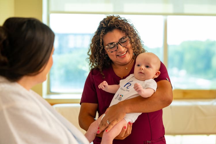 baby in baptist health/wolfson children's onesie