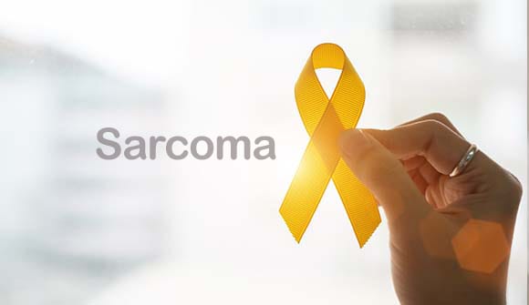 Graphic with yellow ribbon and the word sacroma