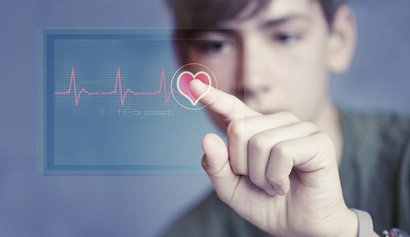 A teen looking at a heart rhythm report