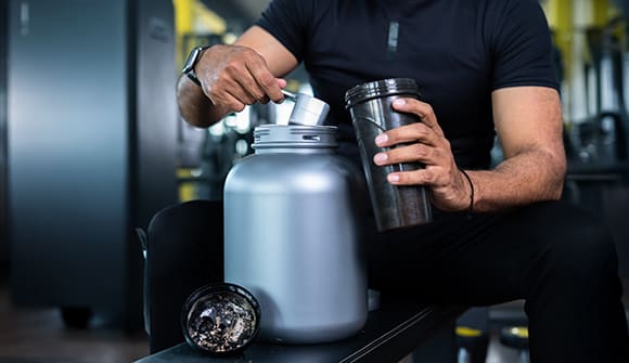 A man mixing up a pre-workout drink.