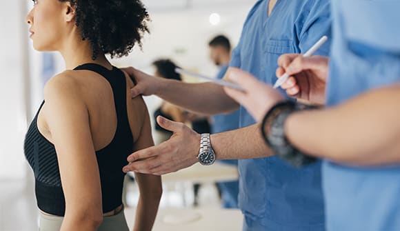 A woman being evaluated for a spinal curve