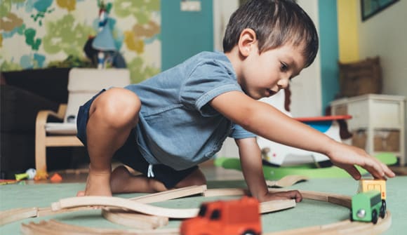 a child playing with trains