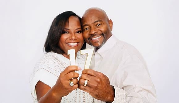 Greg and Lakesha Burton holding sign 17 for their anniversary.