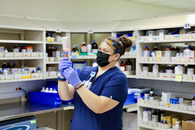pharmacist preparing drugs for a patient