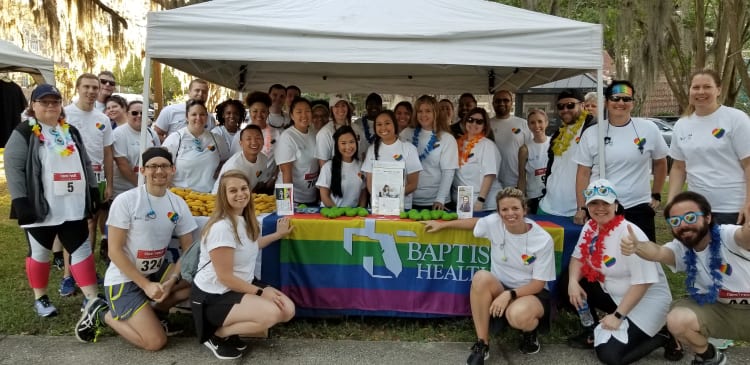 A large group of Baptist Health employees at a community event supporting LBGT+ community.