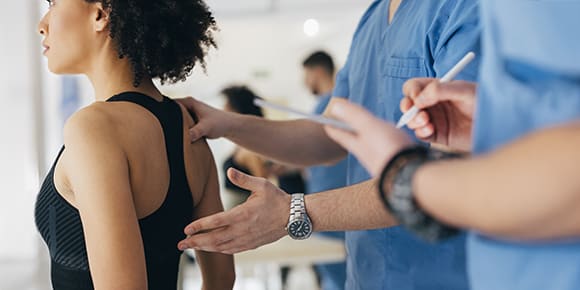 doctor touching a woman's spine