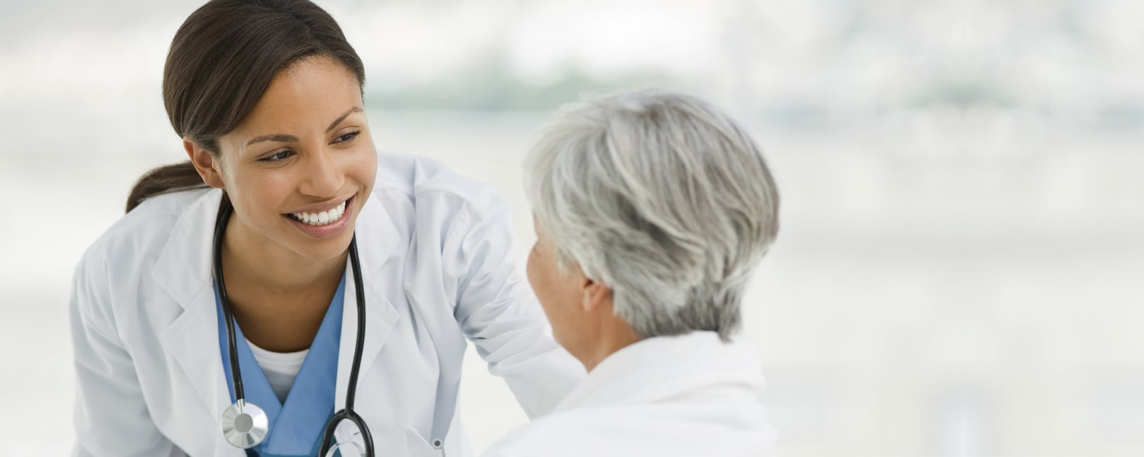 smiling female doctor talking with a female patient