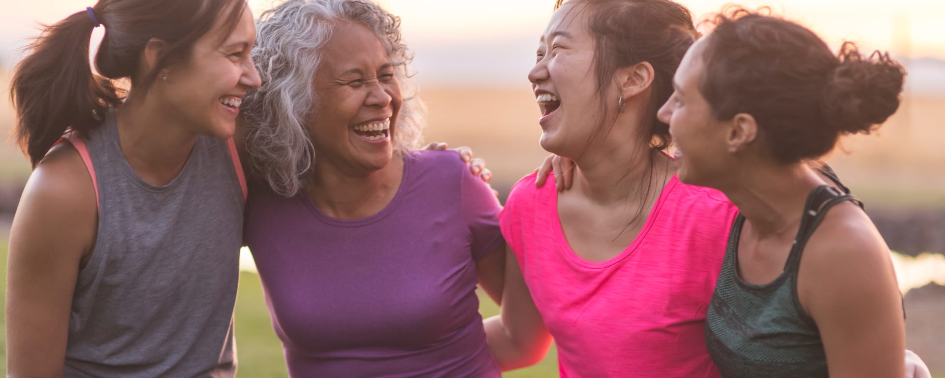 a group of middle-aged women outside laughing together after exersizing