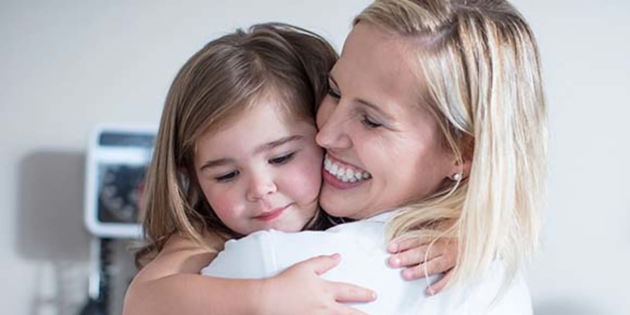 mom hugs her little girl 