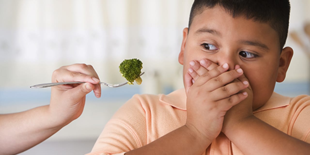 A child refusing to eat broccoli 