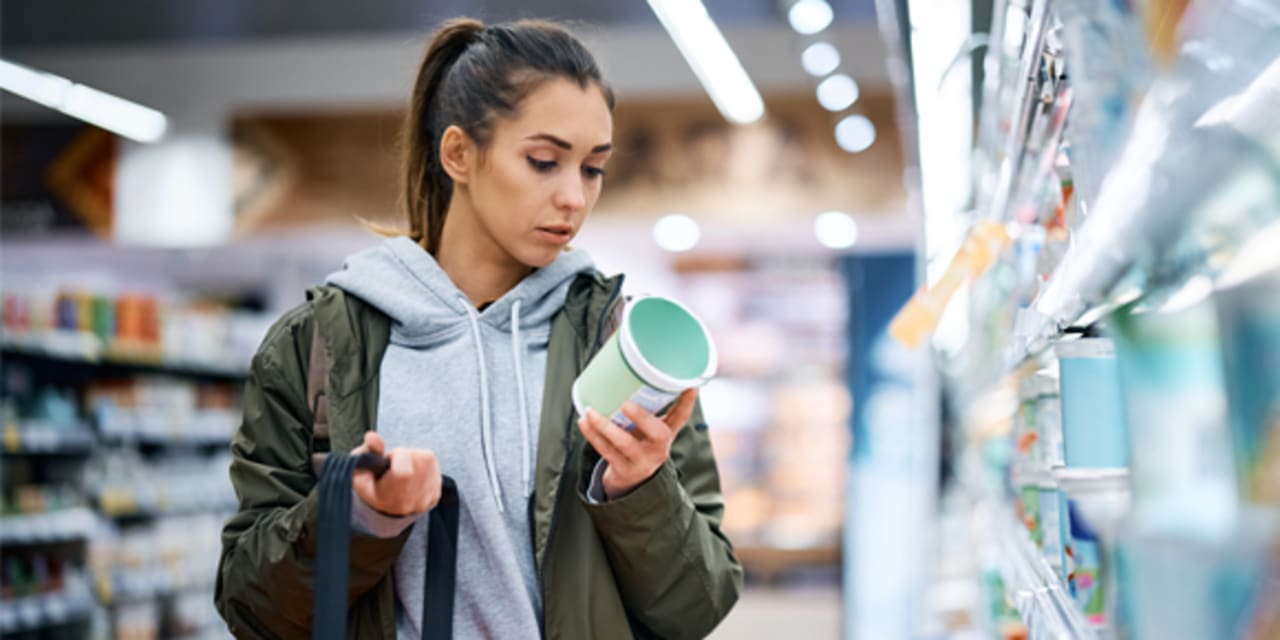 Woman looking at food label