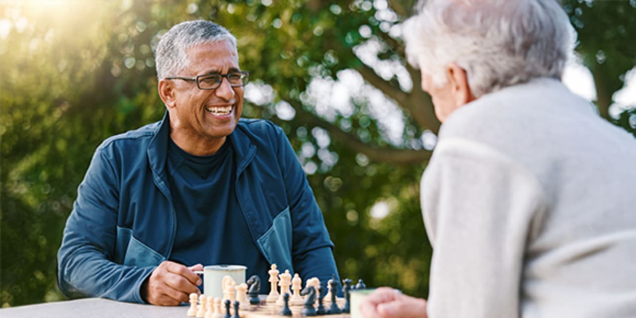 An older couple playing chess
