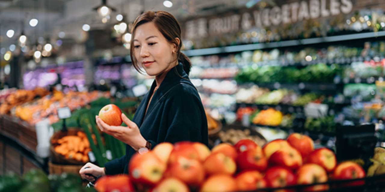 A shopper buying frest fruit at the store