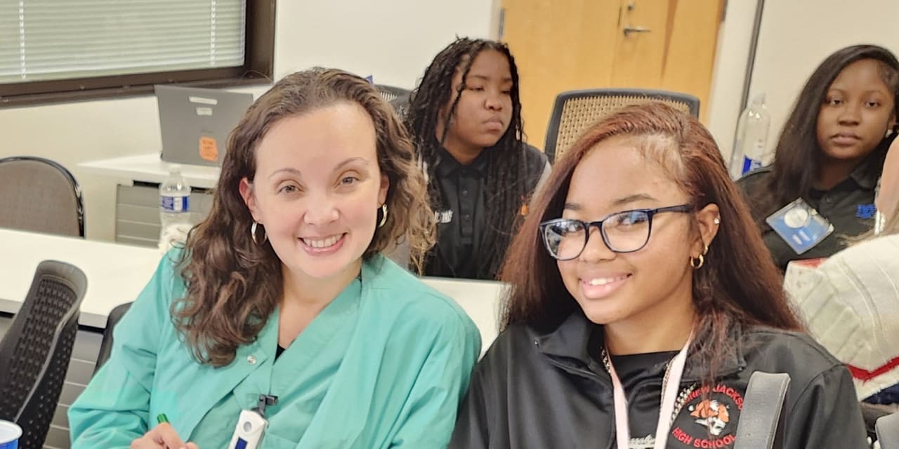 smiling women sitting together in a classroom