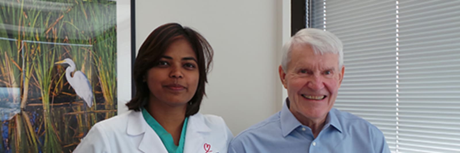 Doctor standing with patient for photo