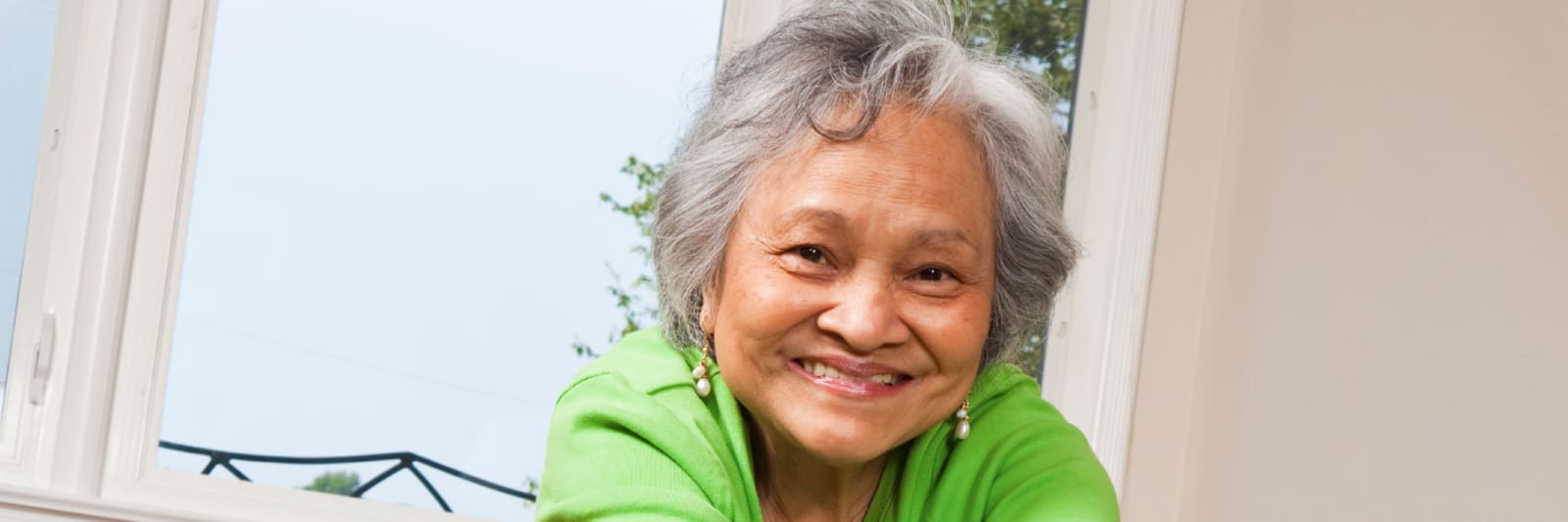 smiling older woman in a green shirt