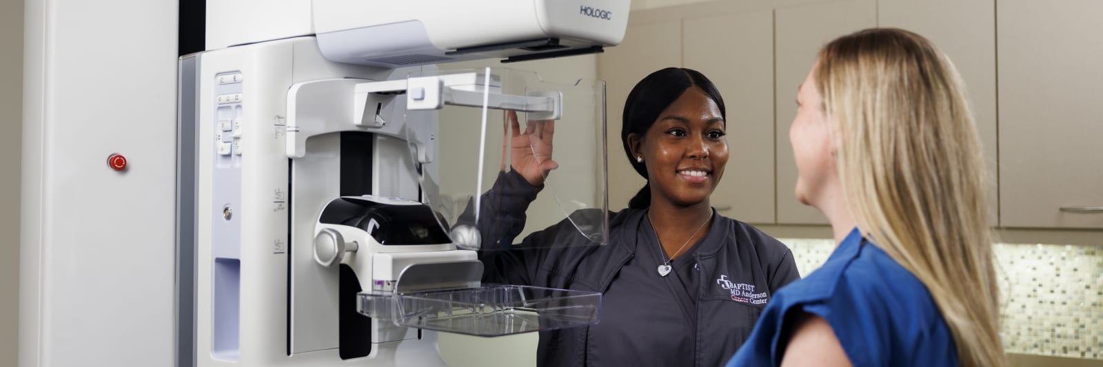 medical worker assisting woman getting a mammogram