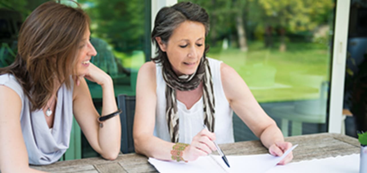 two women going through paperwork