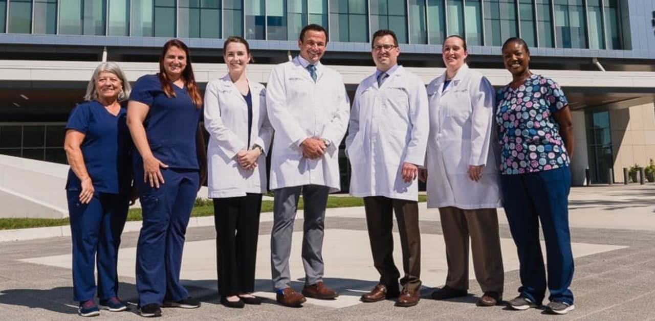 bariatric doctors and nurses standing in front of the hospital