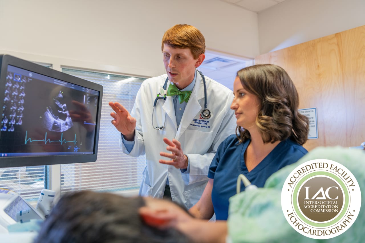 doctor and technician review echocardiogram with patient