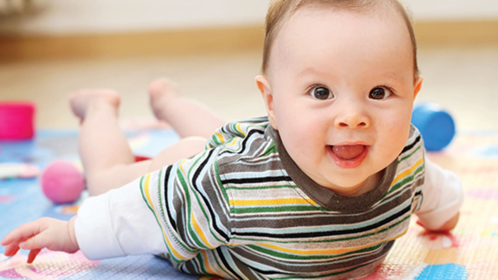 A newborn smiles during tummy time
