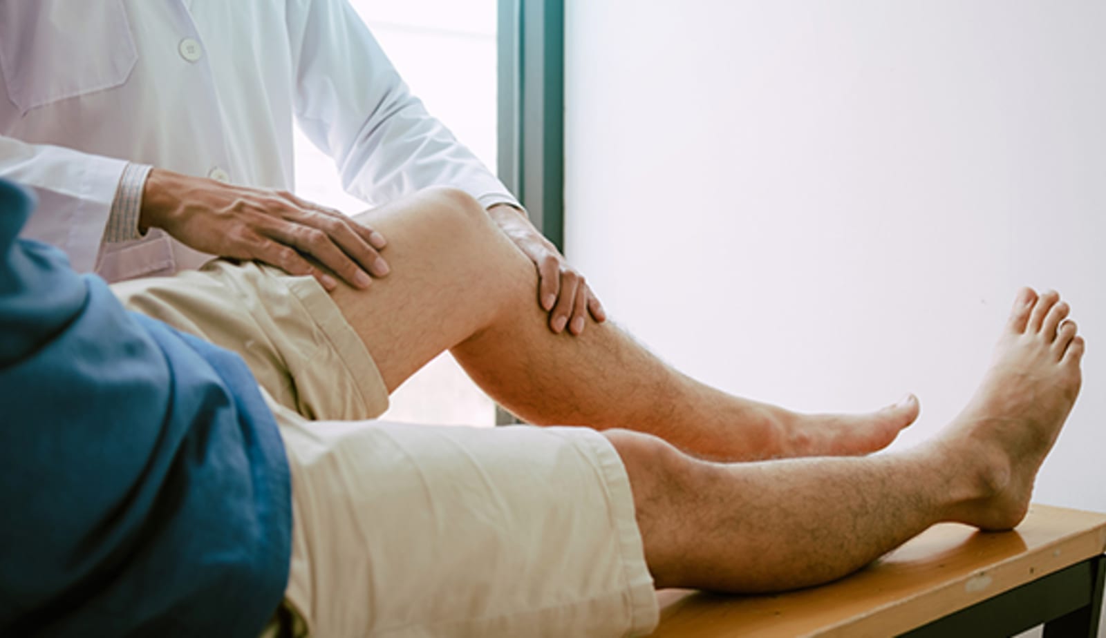 Man having PAD-pain in his leg examined by a doctor.
