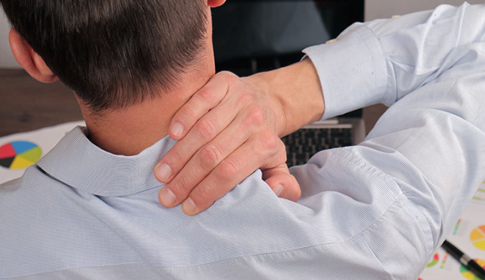 man massaging shoulder