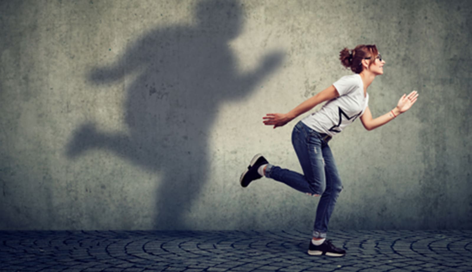 woman and shadow of a woman on a wall