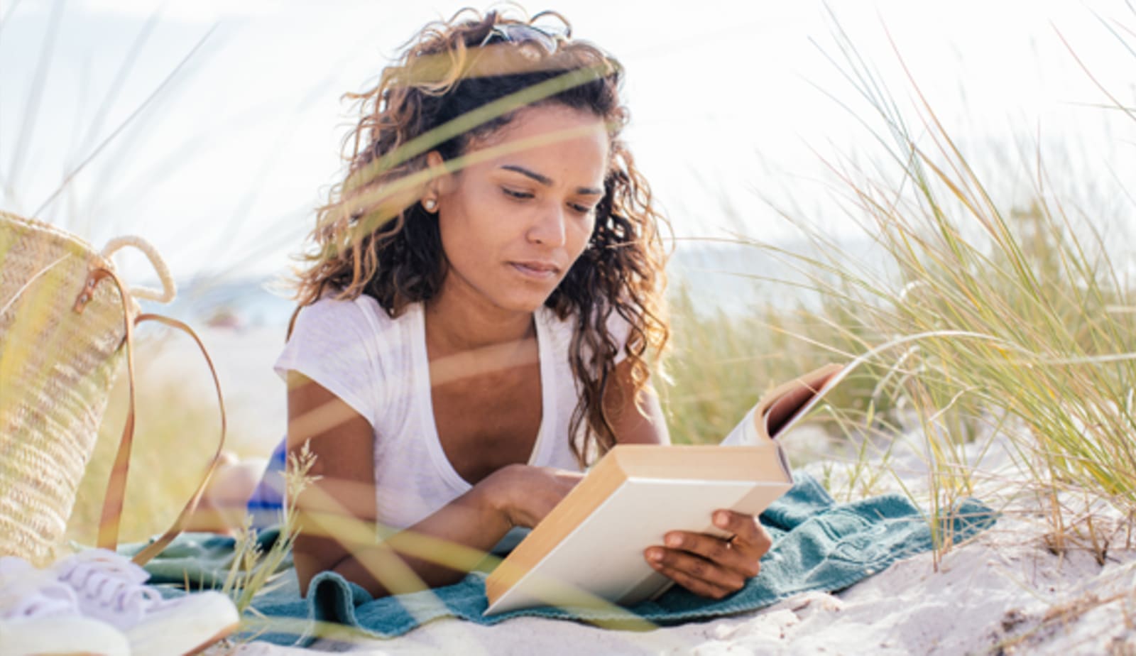 woman reading at the beach