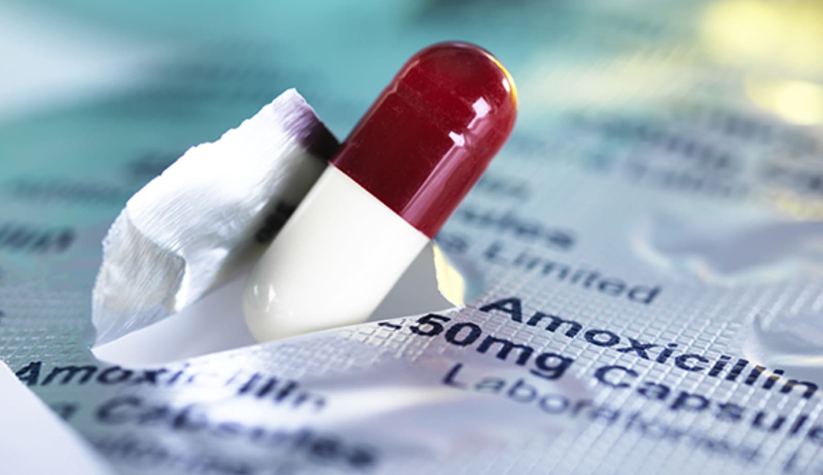 close up image of antibiotic pill coming out of packaging
