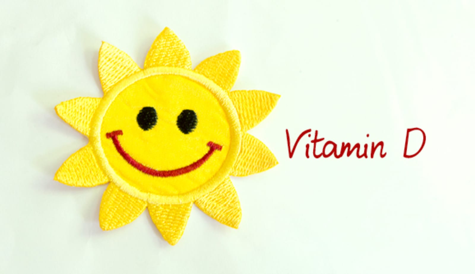 A graphic of the sun with the words Vitamin D next to it