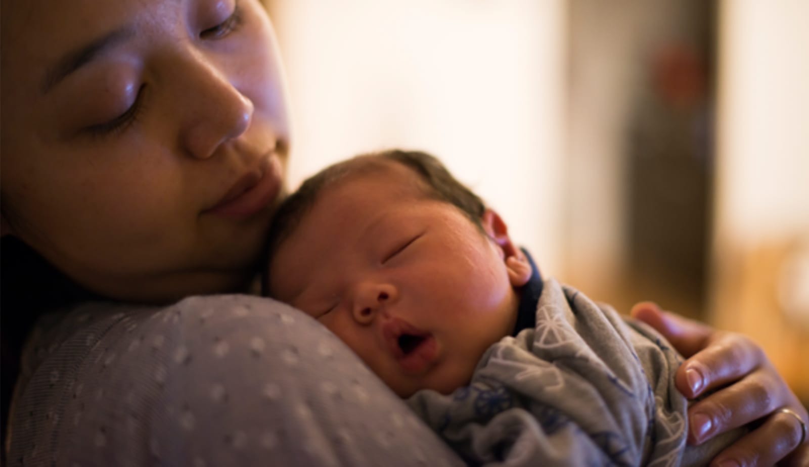 mother holding her sleeping baby
